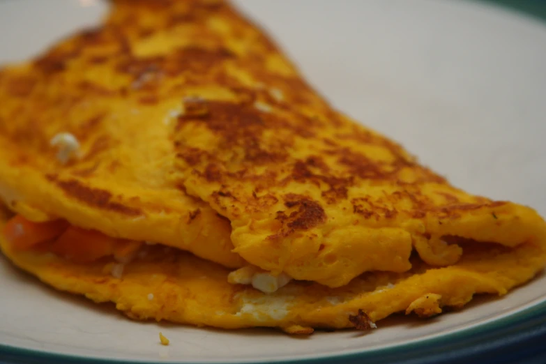 a plate of food with an omelet on it