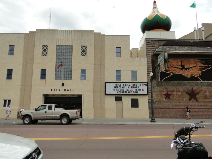 an old building with a lot of windows and a motorcycle parked by it