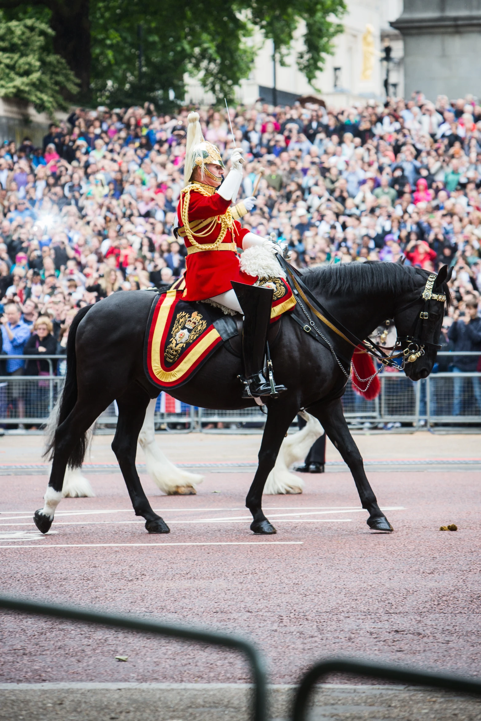 a man riding a horse with a helmet on at an outdoor event