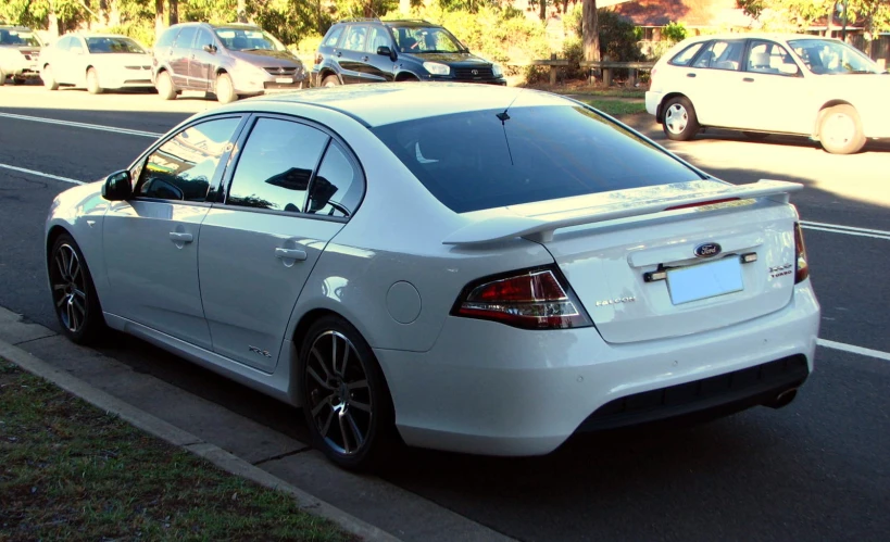 a white car parked on the side of the road