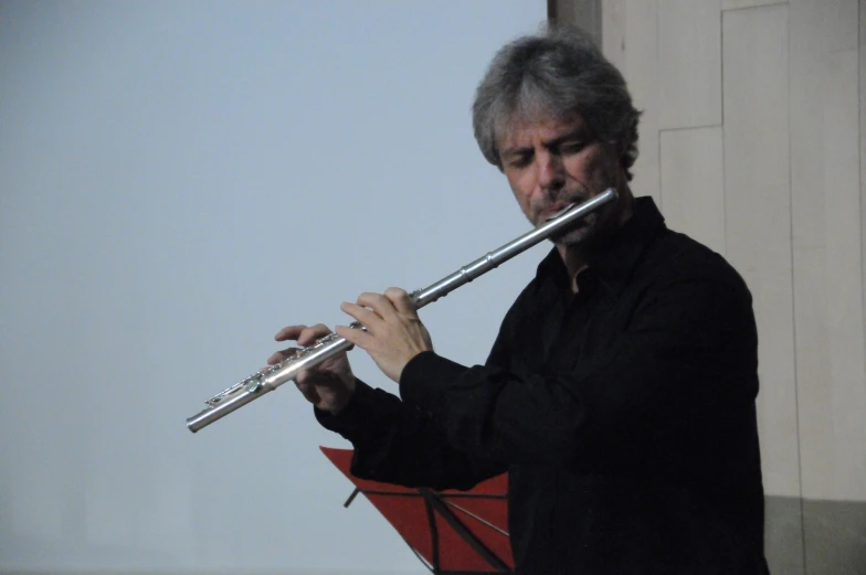 a man is playing the instrument outdoors