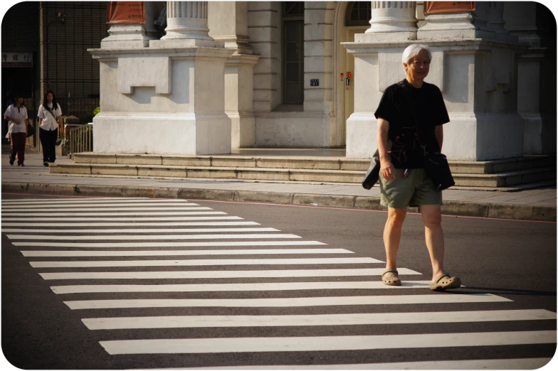 a person crossing the street at an intersection