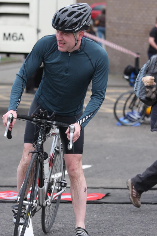 a man riding a bicycle down a street