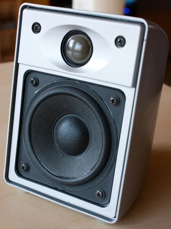 an empty white square speakers set on a table