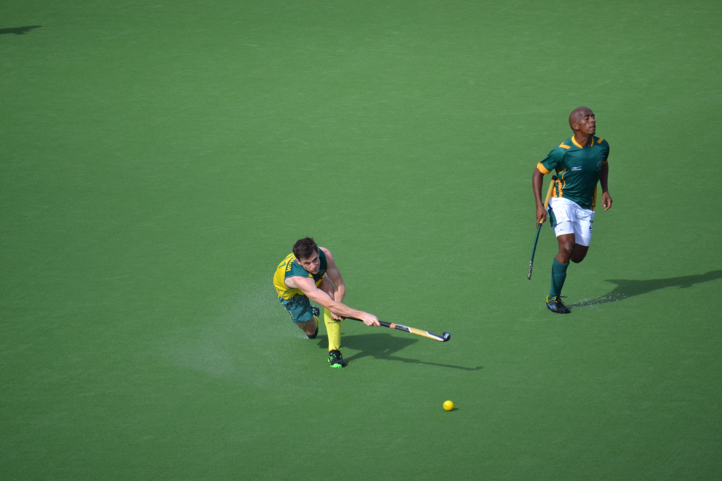 some people are playing soccer on a grass field