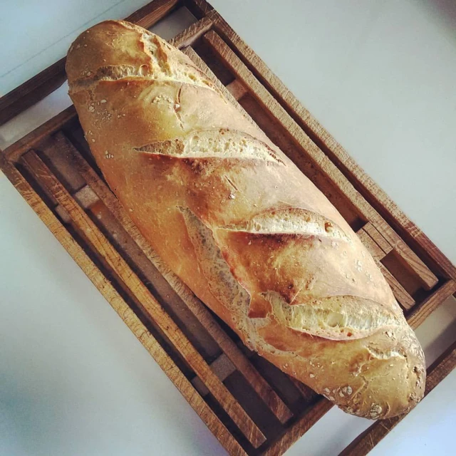 the loaf is on a wooden tray