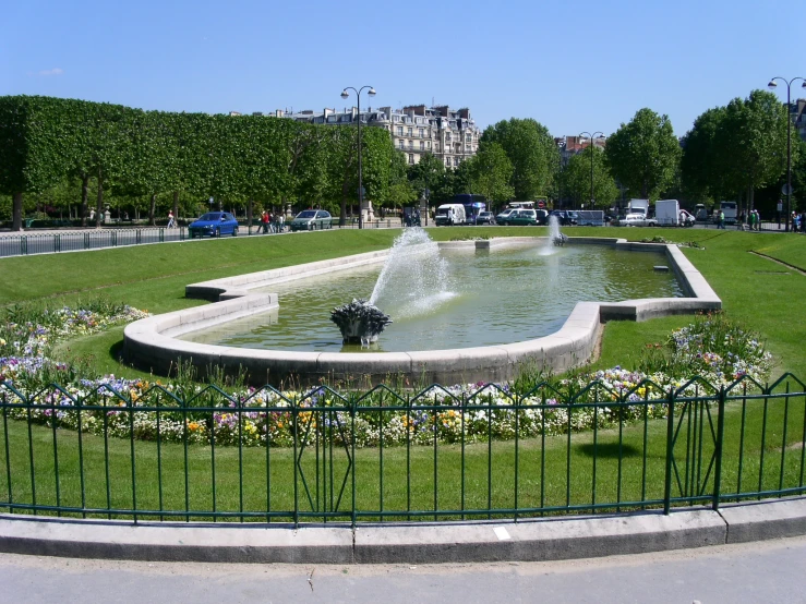 a couple of birds are sitting on the top of a fountain