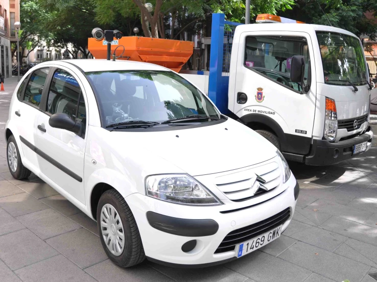 two small vehicles that are sitting in the street