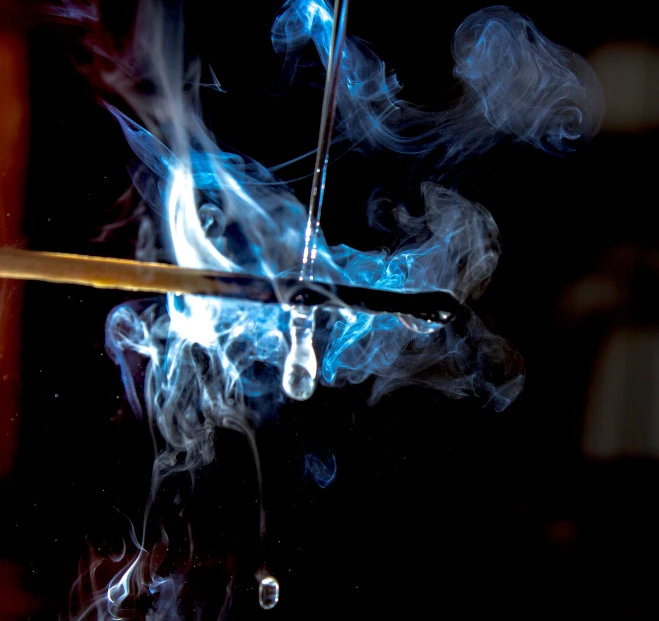 a smoke bomb and a knife with sticks sticking out of it