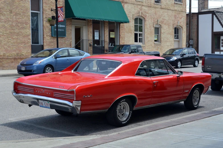 there is an old red car that is parked