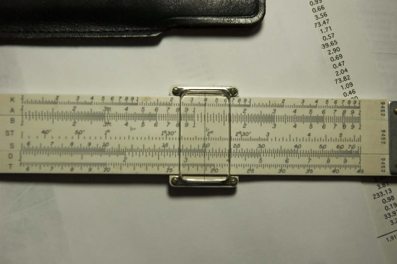 a ruler laying on top of a table near a pencil