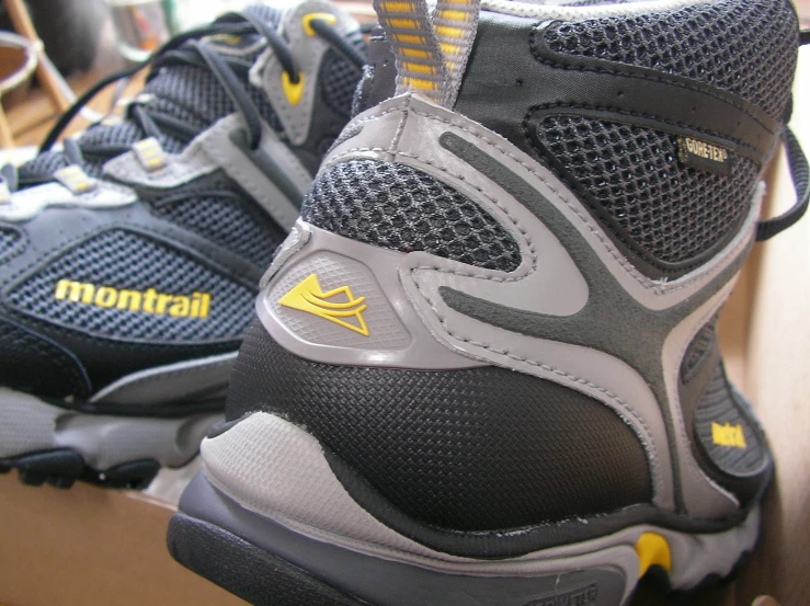 a close up of someone's tennis shoes with yellow lettering