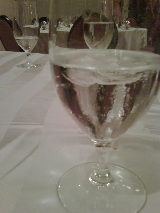 there are three wine glasses with liquid inside