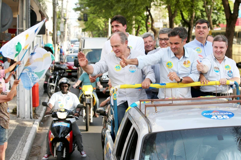 a group of men on a street with motorcycles and a car