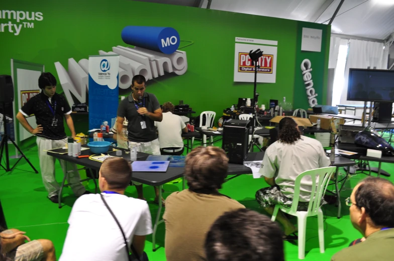 many people sitting around tables during a meeting