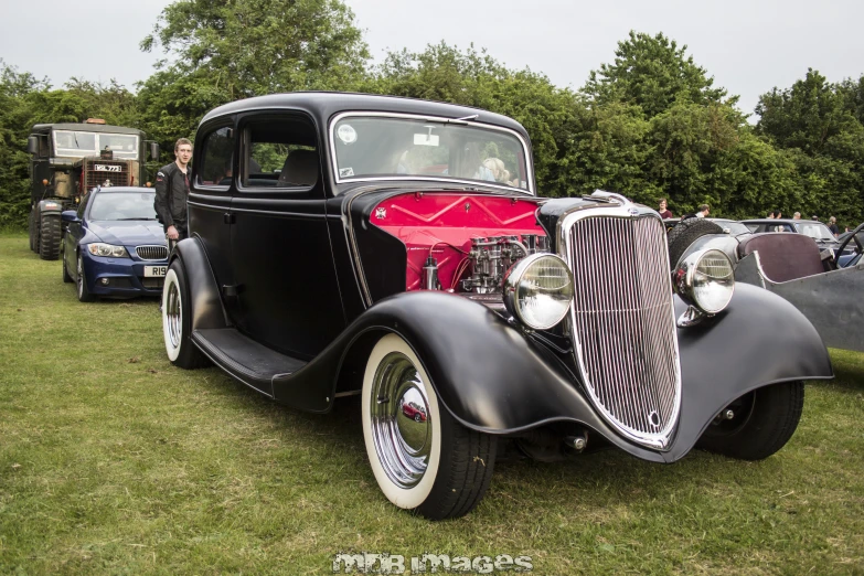 an old car at a show in the grass