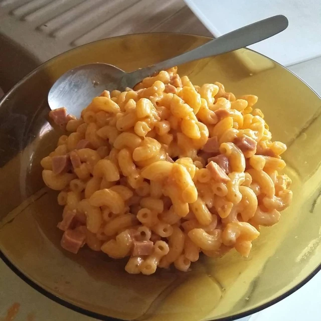 a bowl full of macaroni and cheese with a spoon