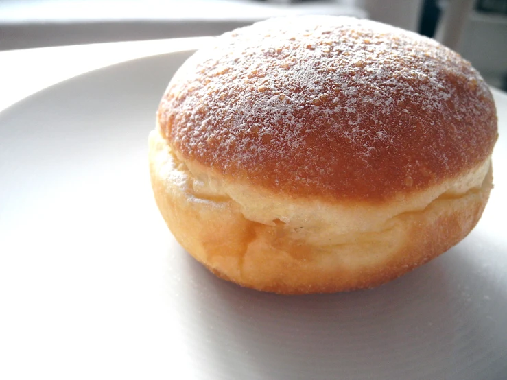 a pastry on a white plate, ready to be eaten