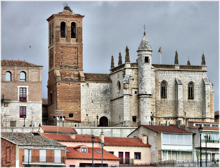 old buildings are in the foreground with one brick tower