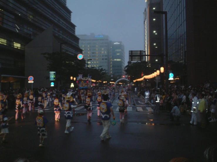 a group of people dressed up in clown costumes crossing a street