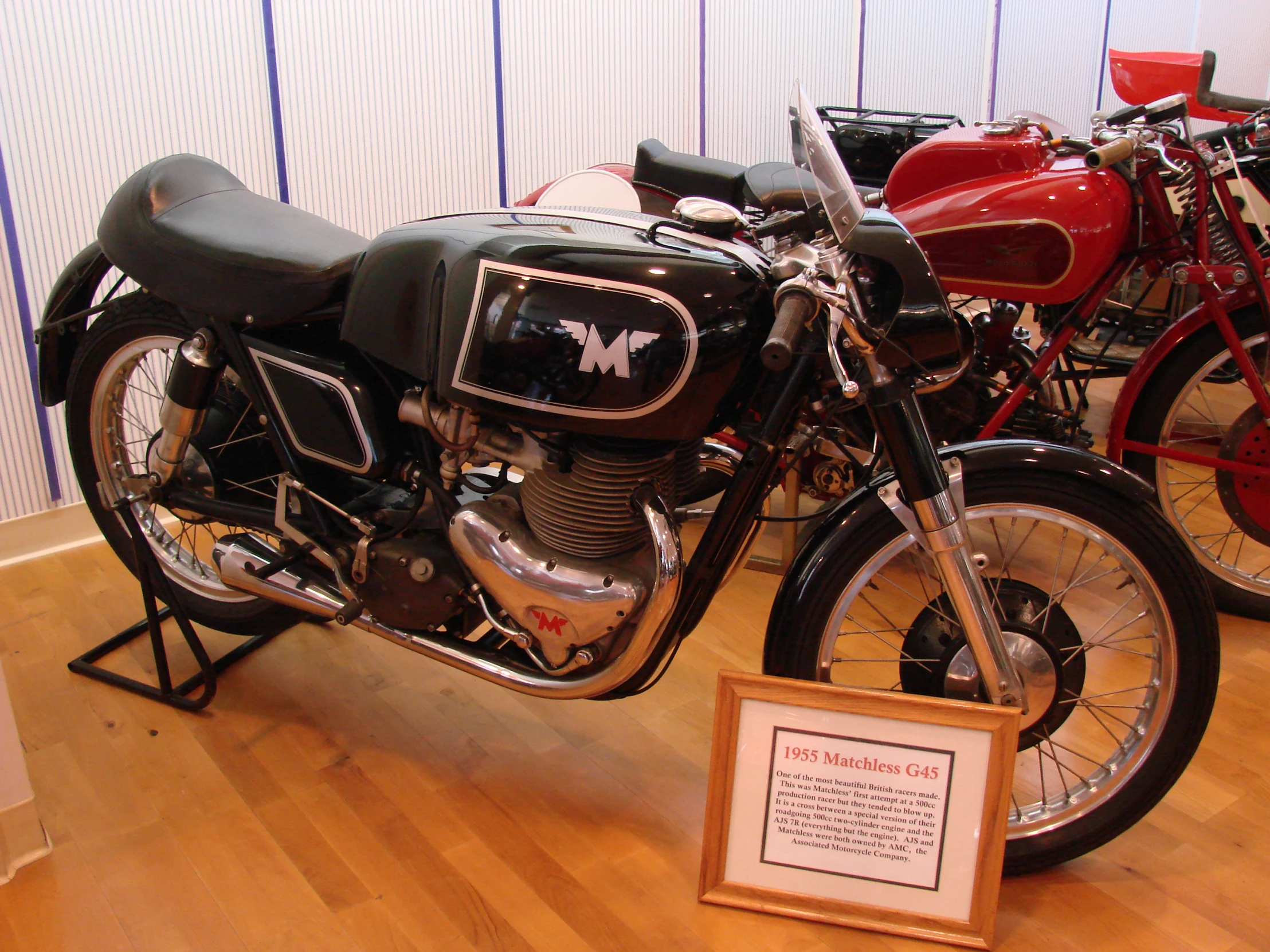 a row of motorcycles sitting on display on a wooden floor