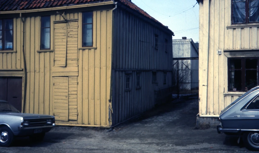 a car is parked outside a old house