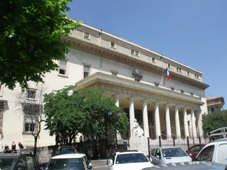 several cars parked in front of an old building