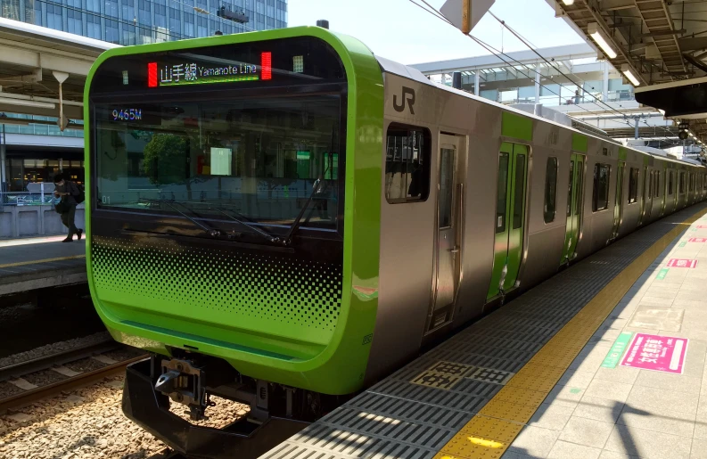 the train is parked on a platform at a station