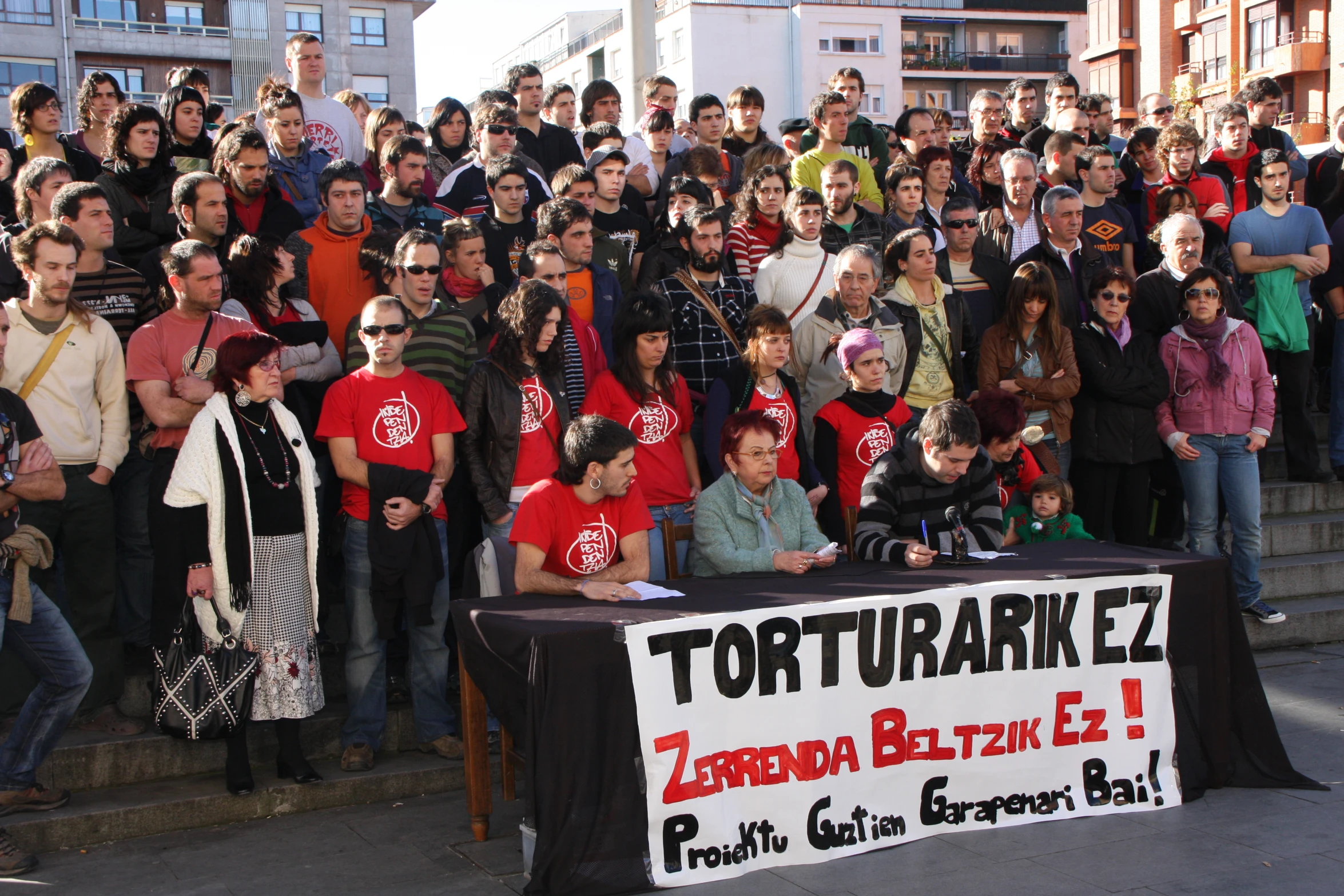 a large group of people with signs and banners