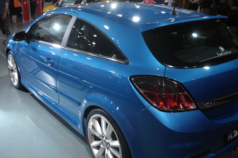 a very bright blue car is on display