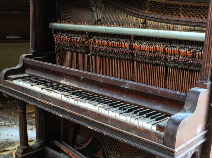 an old, broken piano in an abandoned church