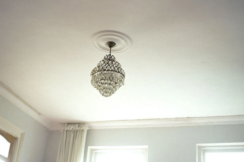 a chandelier hanging from a ceiling in a bedroom