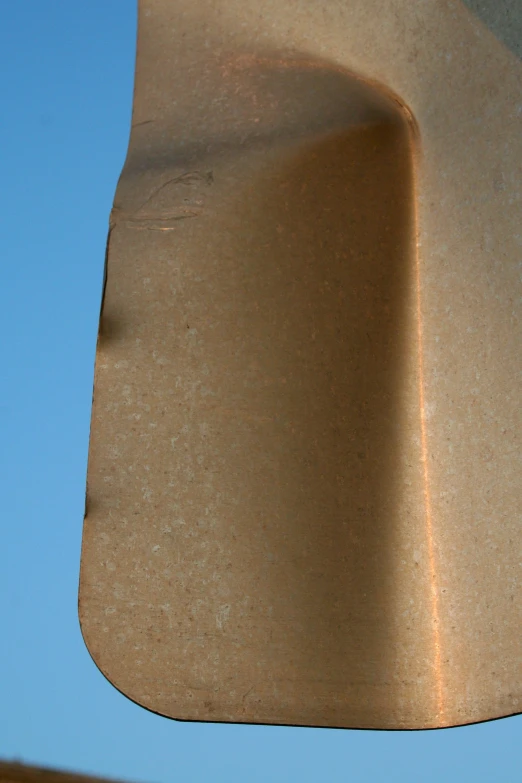 closeup po of part of a large structure against a clear blue sky