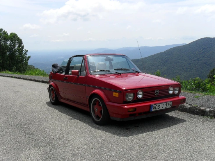 a red car parked on the side of a road