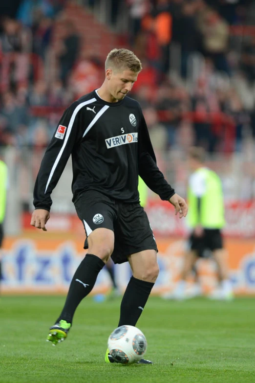 a soccer player gets ready to kick the ball