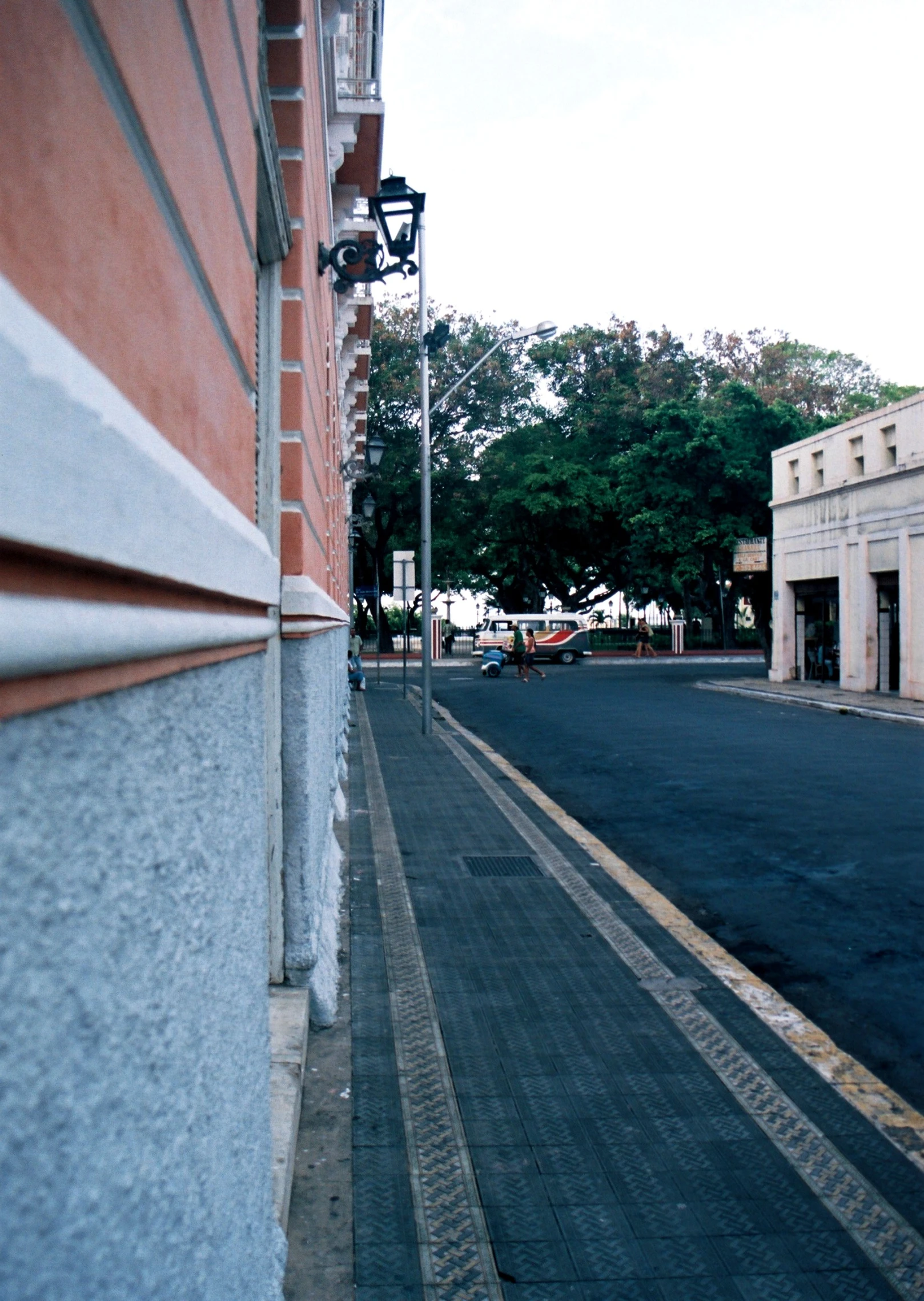 two cars parked on the side of the street next to a building