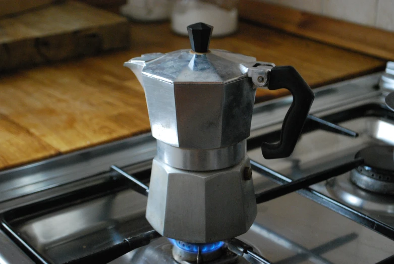 a metal stove top sitting next to a counter