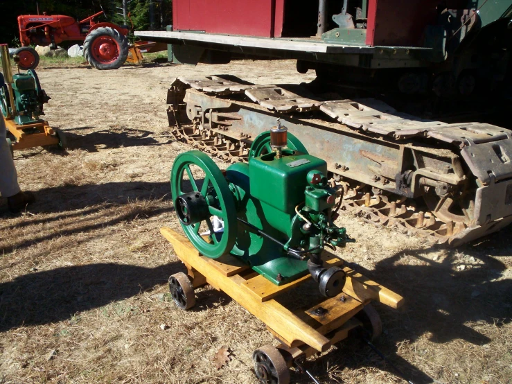 a green engine that is sitting on a cart