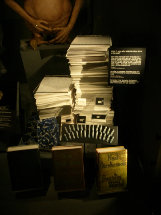 a man stands near stacks of books at a museum