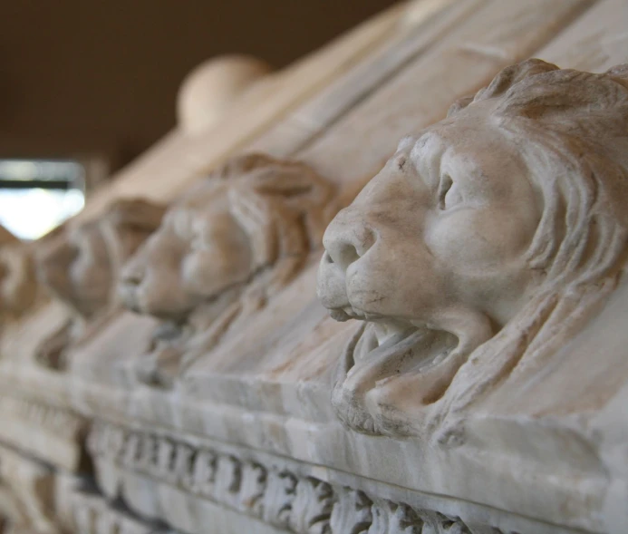 close up po of stone carving of lions heads