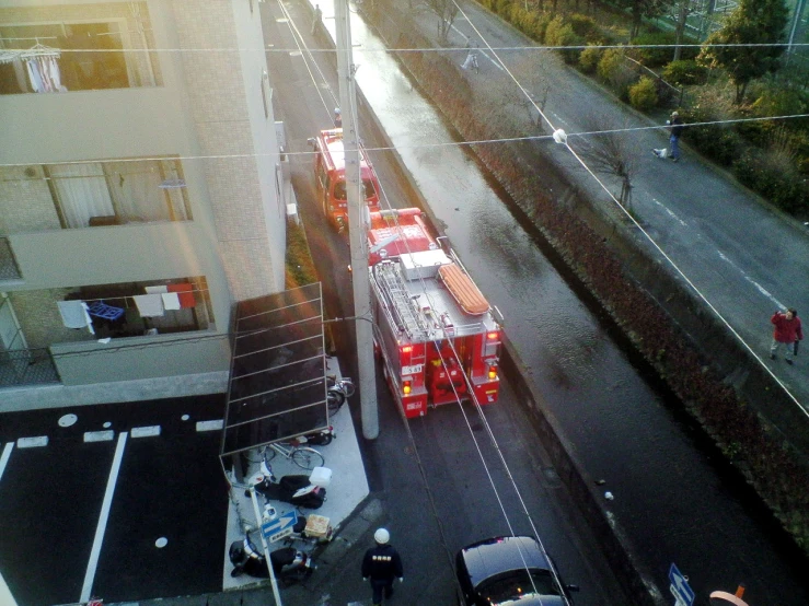 two buses sit idle on a busy city street