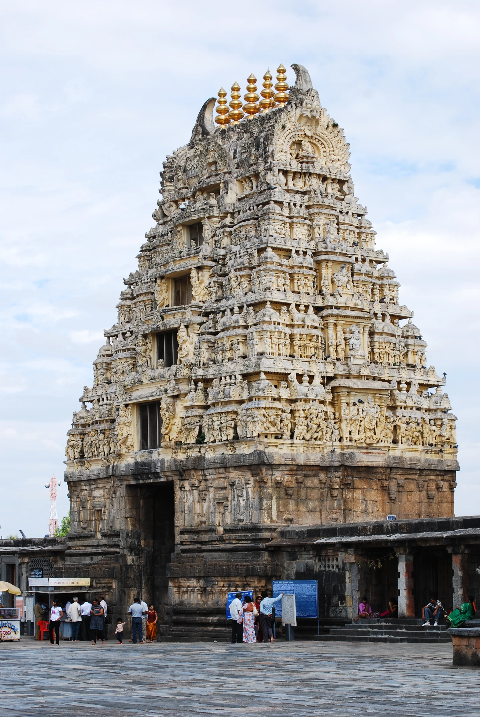 a large ornate hindu temple is near people