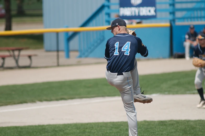 a baseball player in mid - throw throwing a ball