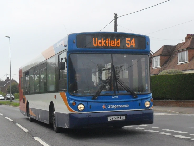 a blue bus that is driving down the street