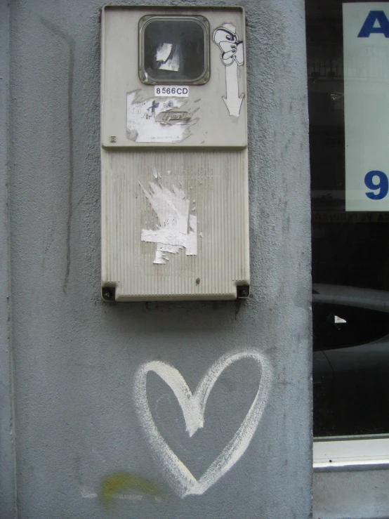 the graffiti on the concrete has been altered and is heart shaped