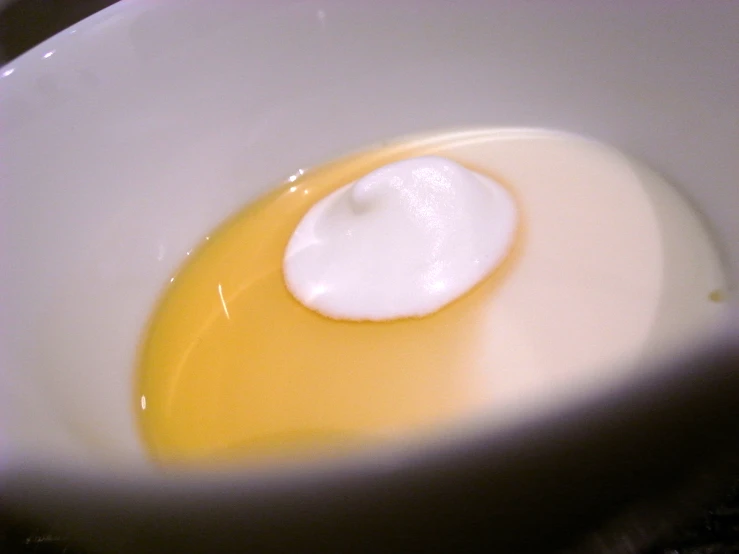 an egg is being cooked in a bowl