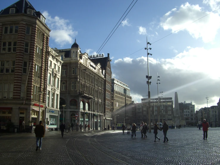 a city square has pedestrians on one side and people on another