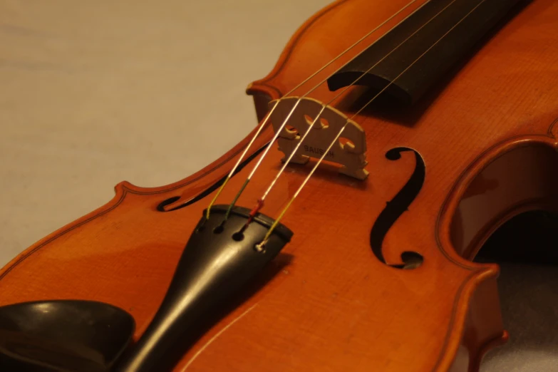 a close up of a violin on a surface