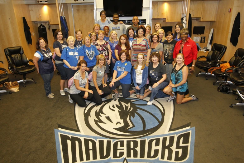 some women are posing for a picture with a basketball team