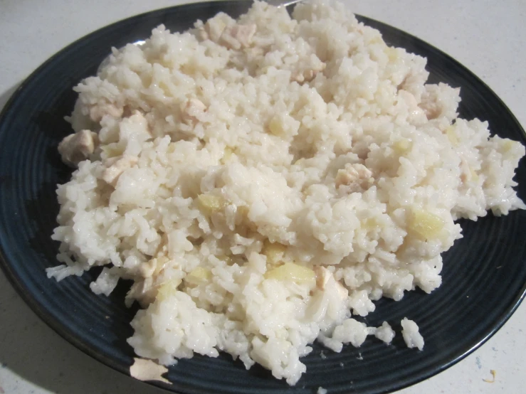 cooked rice and potatoes is served on a plate